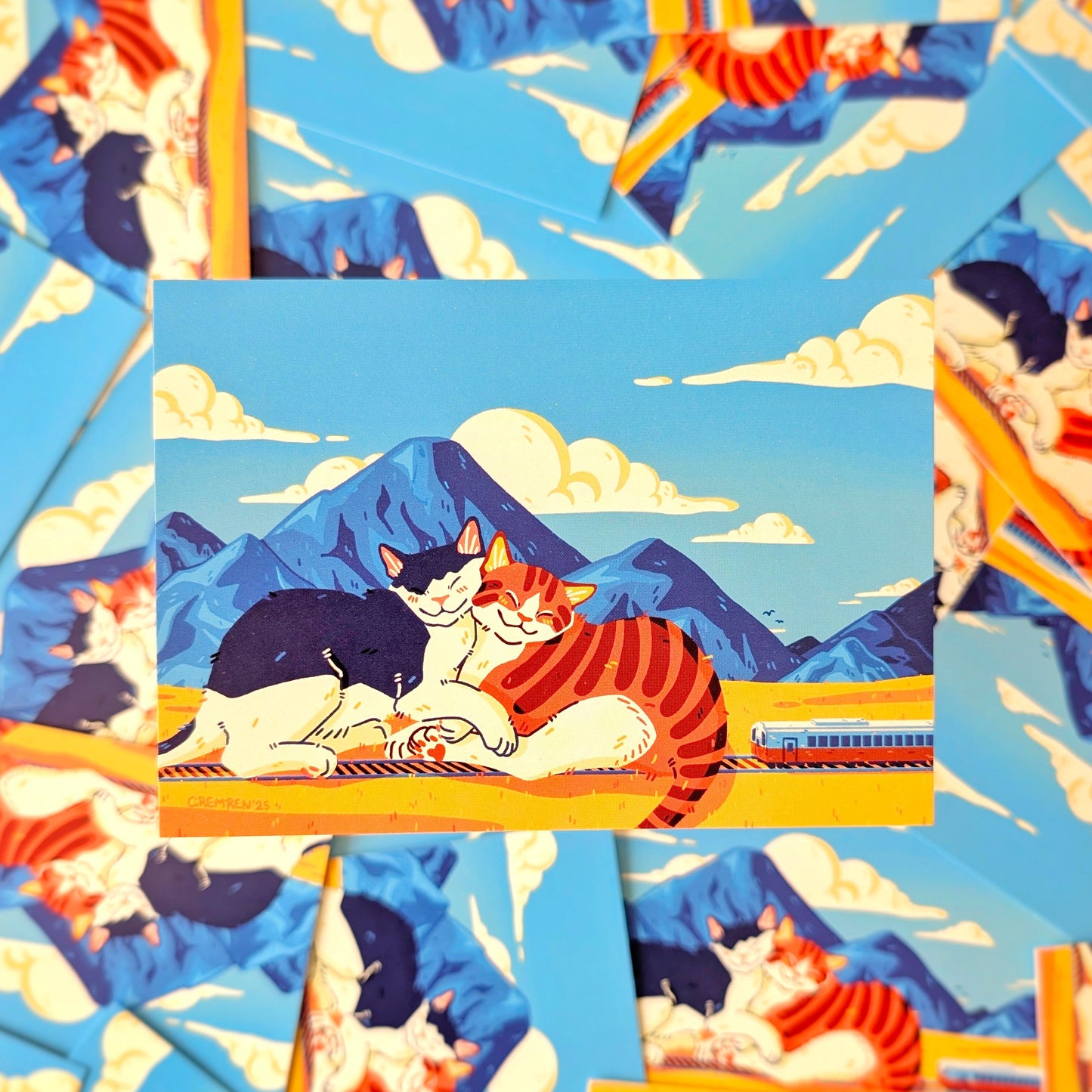 Illustration of cats on a mountain with a train, surrounded by similar illustrations.