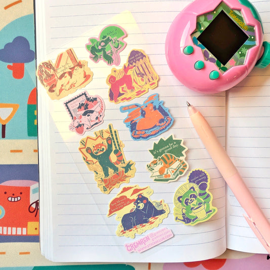 Colorful sticker sheet with pink Tamagotchi toy on a notebook