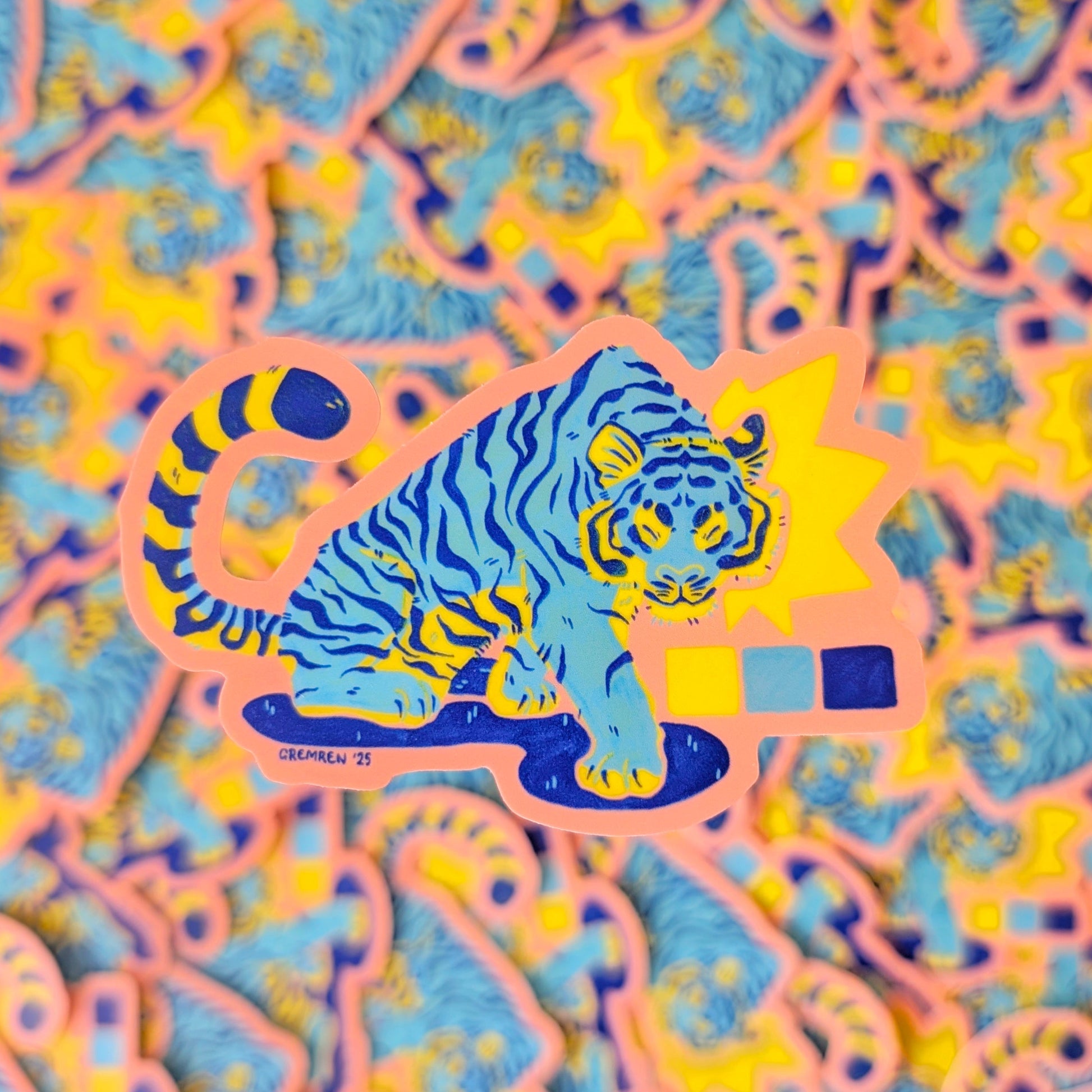 Colorful patterned background with a blue tiger sticker in the center